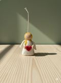 Angel with red heart ornament
